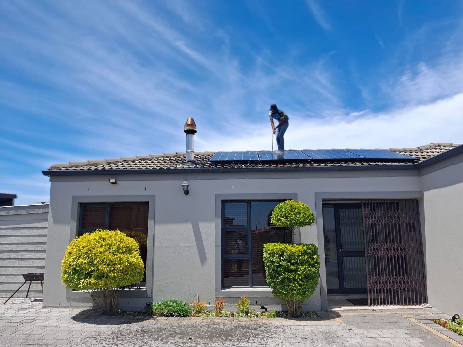 Licensed crew working on a residential roof to safely remove a solar system and restore the roof